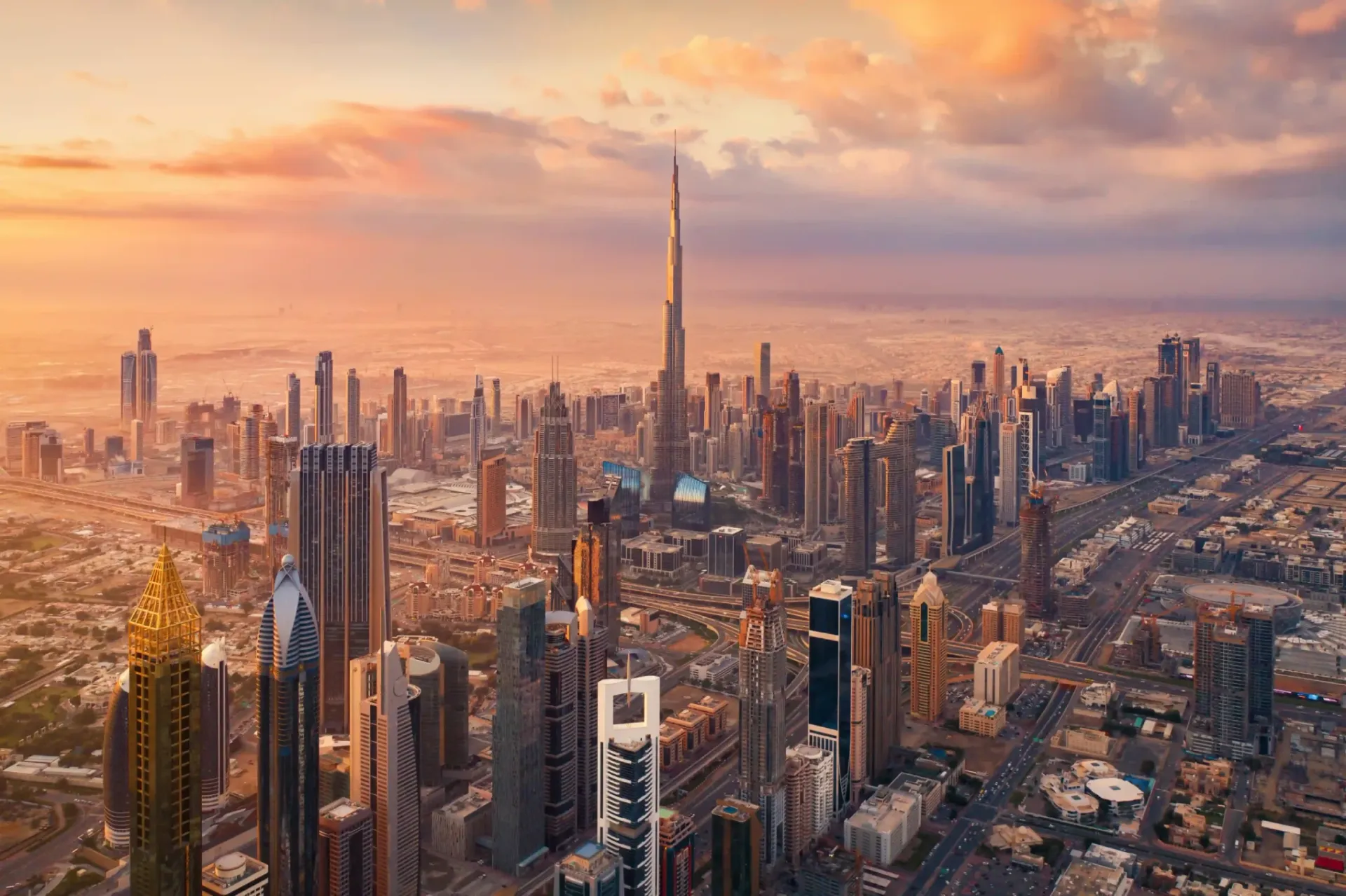 Aerial view of Downtown Dubai at sunset with Burj Khalifa and surrounding towers